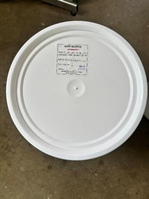 Photograph label on white bucket of Soft Ricotta Cheese, 5 gallon
