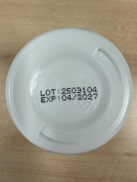 Photograph of bottom of TNVitamins bottle showing LOT: 2503104 and EXP: 04/2027